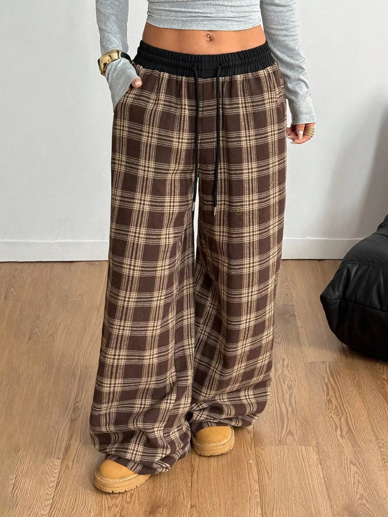 Model wearing GirlSavvi’s Plaid Wide Leg Pants with adjustable drawstring and functional pockets for casual or elevated styling.