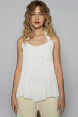 Woman wearing the POL Backless Halter Sleeveless Top with Smocking Shirring Detail in white.