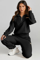 Woman wearing a black Quarter Zip Top and Drawstring Pants Active Set