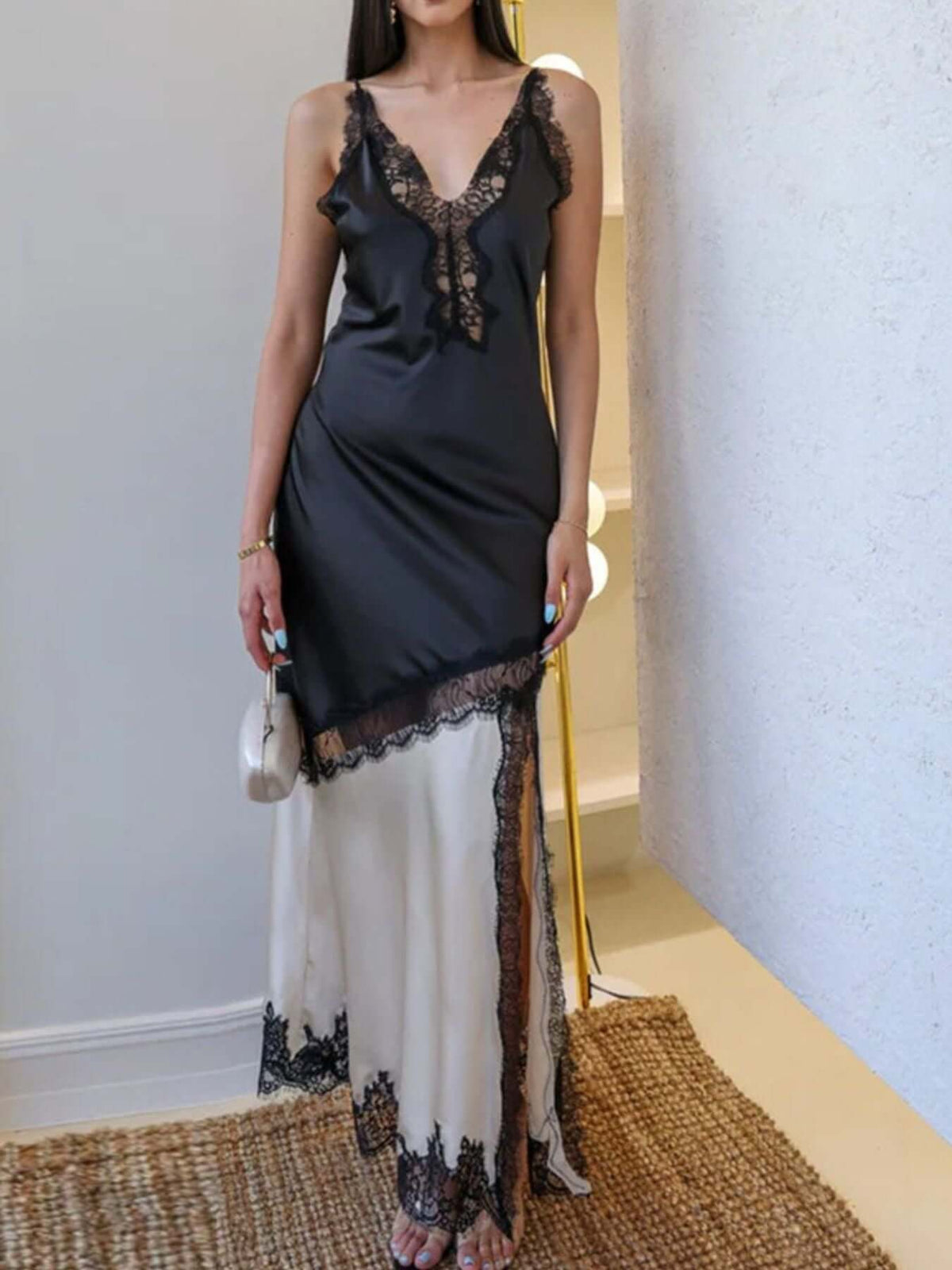 Black Cream Lace Trimmed Two-Tone Slip Dress worn by a model, featuring lace detailing and a split design.