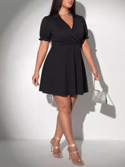 Black Plus Size Short Sleeve Mini Dress featuring a V-neckline, ruched bodice, and flared skirt, perfect for nights out.