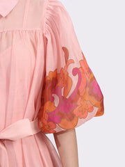 Detail of Button Front Puff Sleeve Dress in blush with floral accents, featuring a puff sleeve and belted waist for a romantic look.