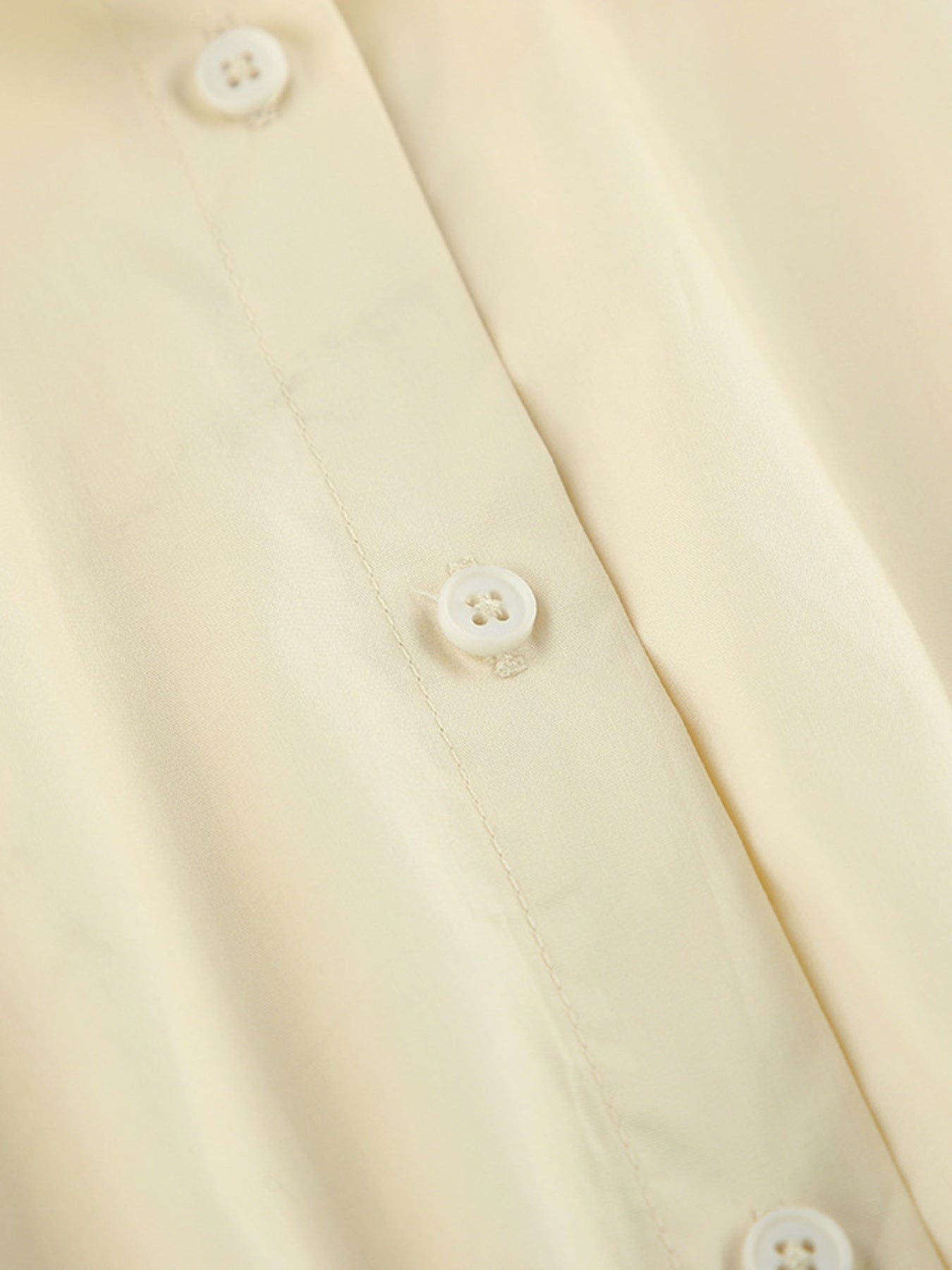 Close-up of buttons on the Button Front Bubble Hem Dress, showcasing its classic button-down design.