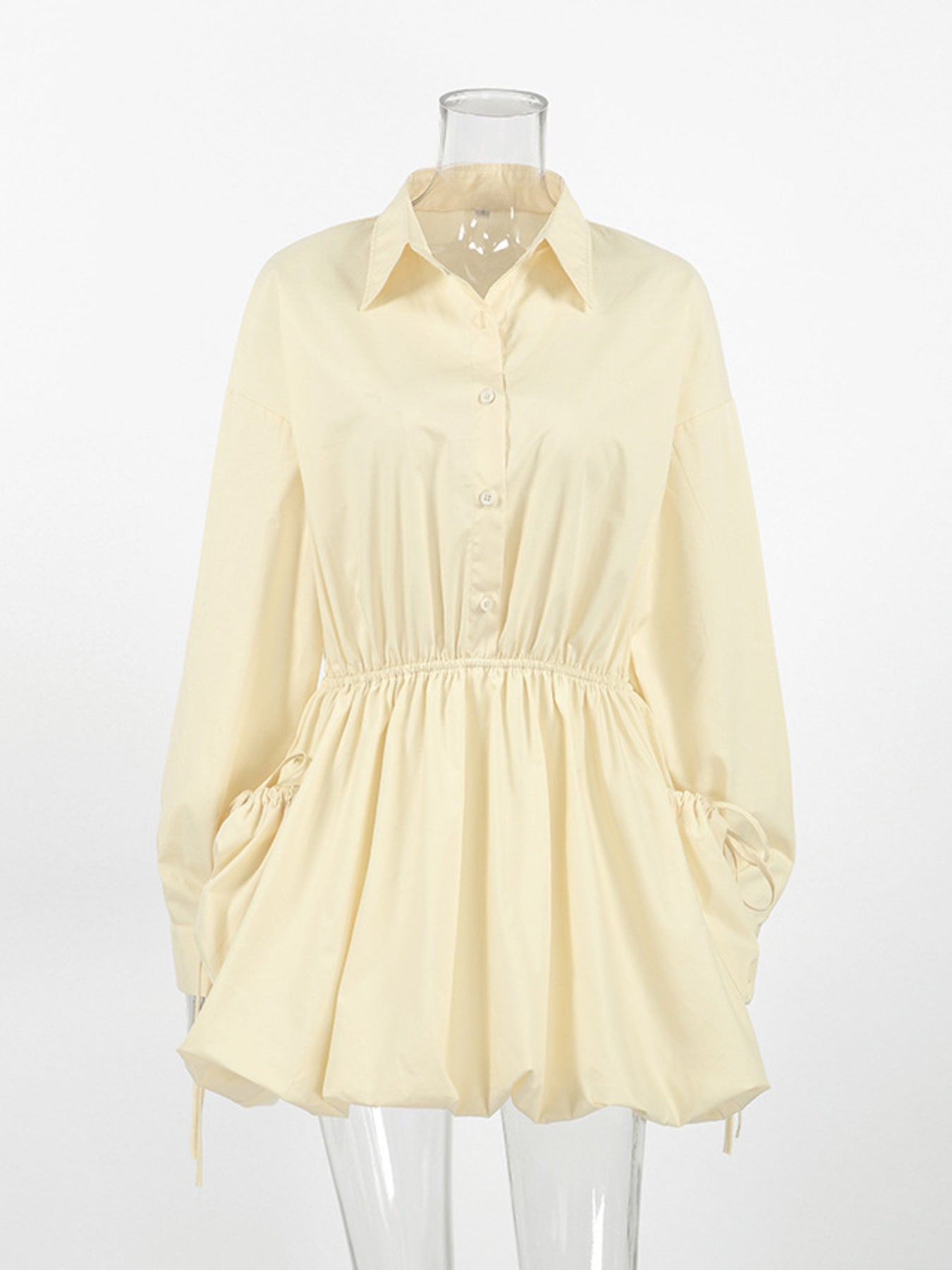 Button Front Bubble Hem Dress - oversized shirt dress with bubble hem and button-down front in light yellow.