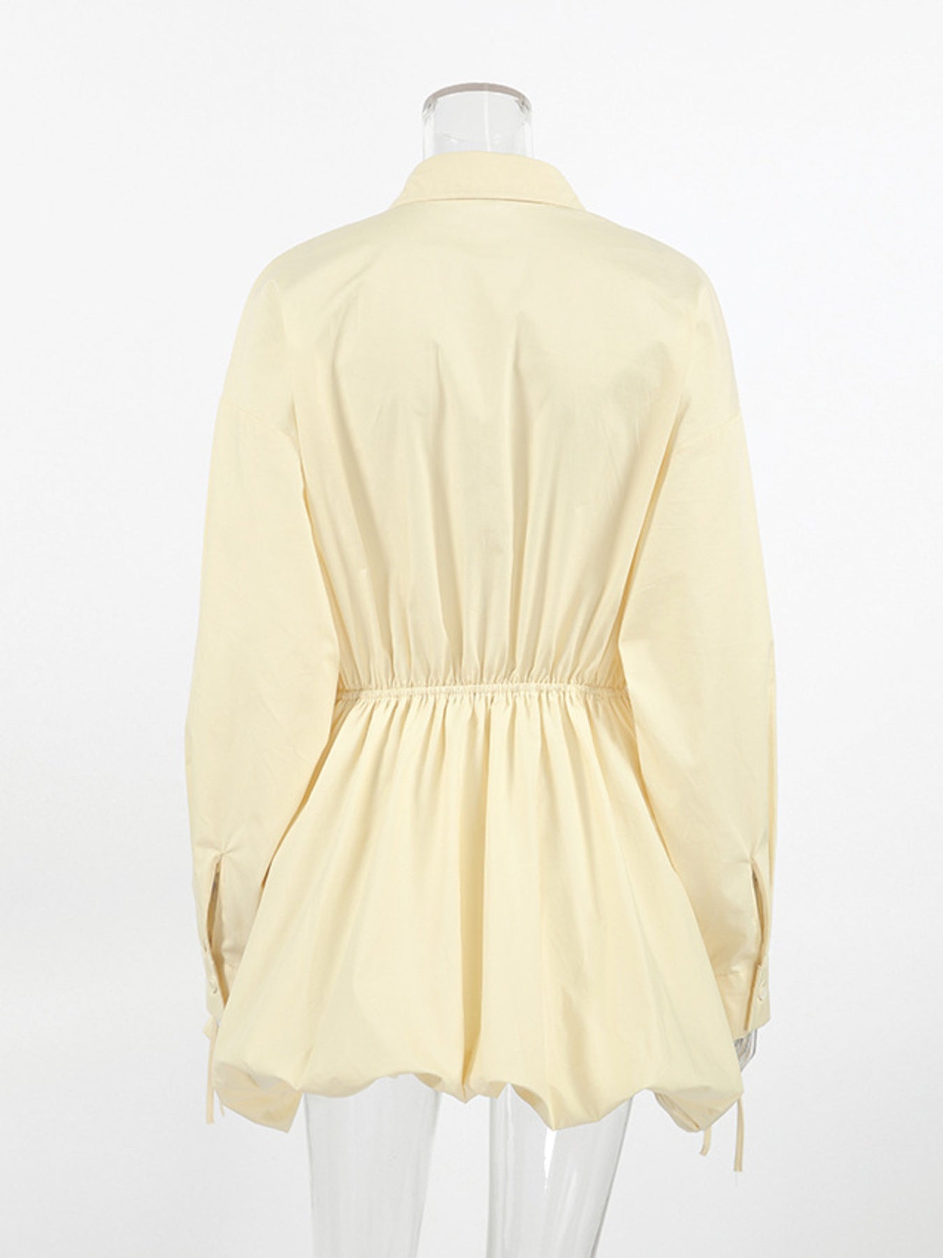 Back view of Button Front Bubble Hem Dress showcasing its playful bubble hem and elastic waist design.