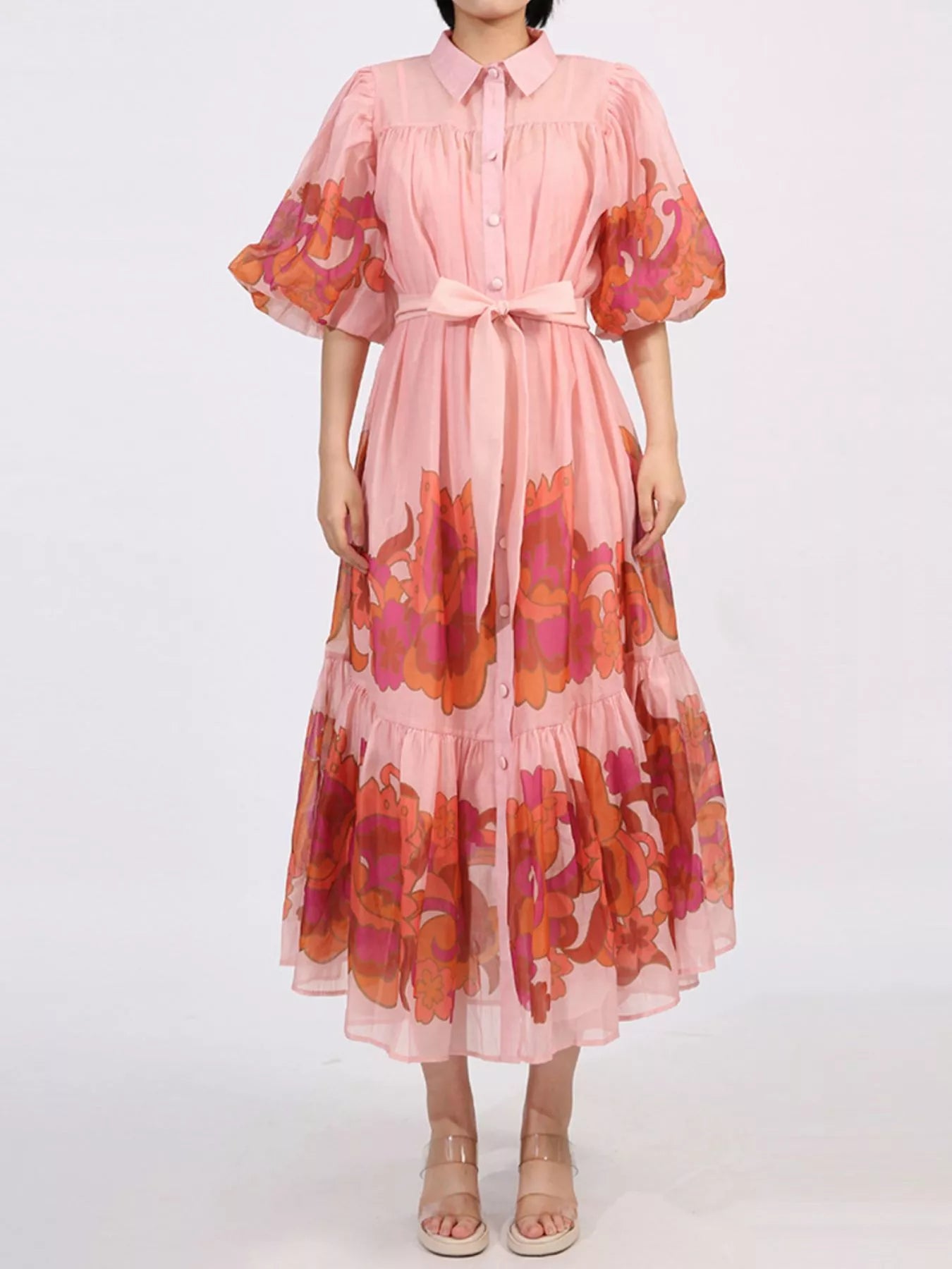 Blush button front puff sleeve dress with floral accents, belted waist, and tiered ruffle hem, offering a romantic no-stretch silhouette.