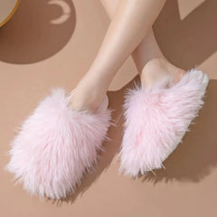 Model wearing pink round toe flats slippers with soft fluff and PVC sole, perfect for comfy indoor lounging.