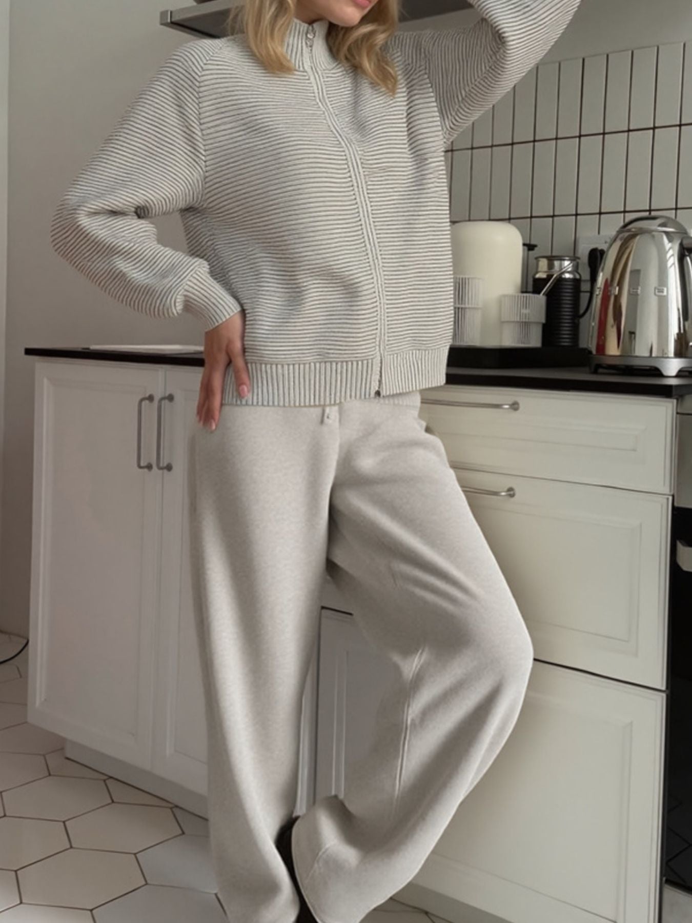 Casual Knit Cardigan and Wide-Leg Pants Set worn by a model in a kitchen, showcasing a relaxed style and soft colors.