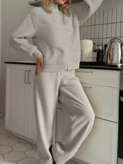 Casual Knit Cardigan and Wide-Leg Pants Set worn by a model in a kitchen, showcasing a relaxed style and soft colors.