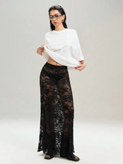 Chic black lace maxi skirt worn with a white top, blending elegance with an edgy twist, perfect for layering over various outfits.