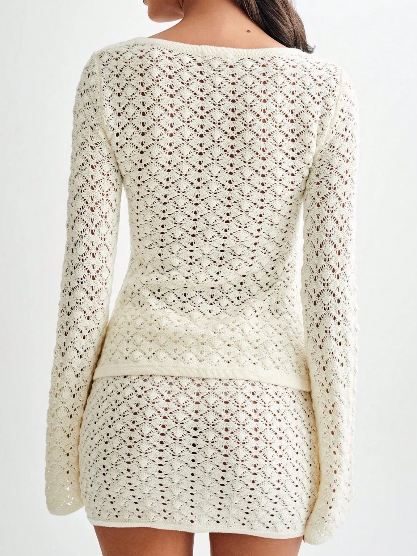 Back view of a woman wearing a Button Up Crochet Cardigan and Skirt Sweater Set, showcasing the textured knit design.