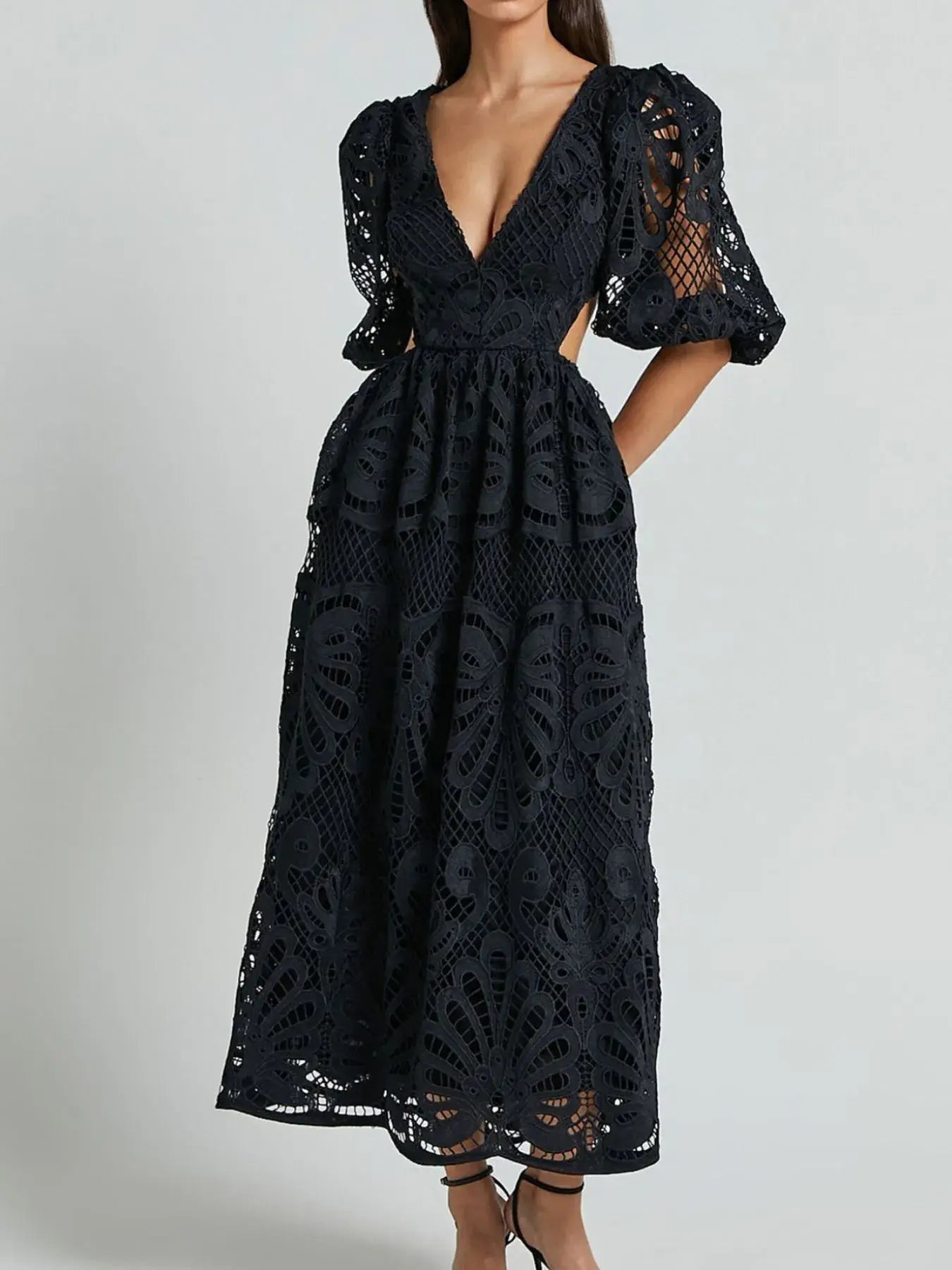 Elegant black lace crochet V-neck dress with cutout back, featuring intricate detailing and bold sleeve design.
