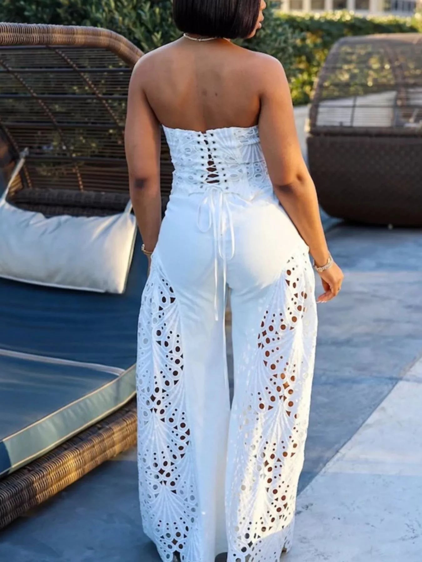Woman in a white Cutout Tube Top and Wide Leg Pants Set, showcasing a stylish back view by a poolside.