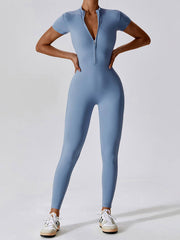 Blue Basic Bae Half Zip Short Sleeve Active Jumpsuit with front zip and short sleeves, designed for sporty comfort and sleek movement.