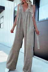V-Neck Sleeveless Denim Jumpsuit with Pockets in khaki tone, featuring smocked back and relaxed wide-leg fit.