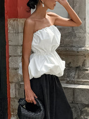 Woman wearing strapless Ruched Bubble Hem Tube Top with ruched bodice and bubble hem, styled outdoors.