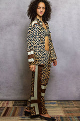 Woman wearing POL Leopard Printed Woven Wide Leg Drawstring Pants with matching top, showcasing stylish and bold leopard print outfit.