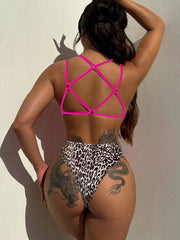 Back view of classic Leopard Plunge Swimwear with pink crisscross straps and high-cut bottom for a sexy silhouette.