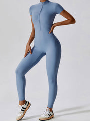 Side view of blue Basic Bae Half Zip Short Sleeve Active Jumpsuit showing stretch fit and sporty design for active lifestyles.