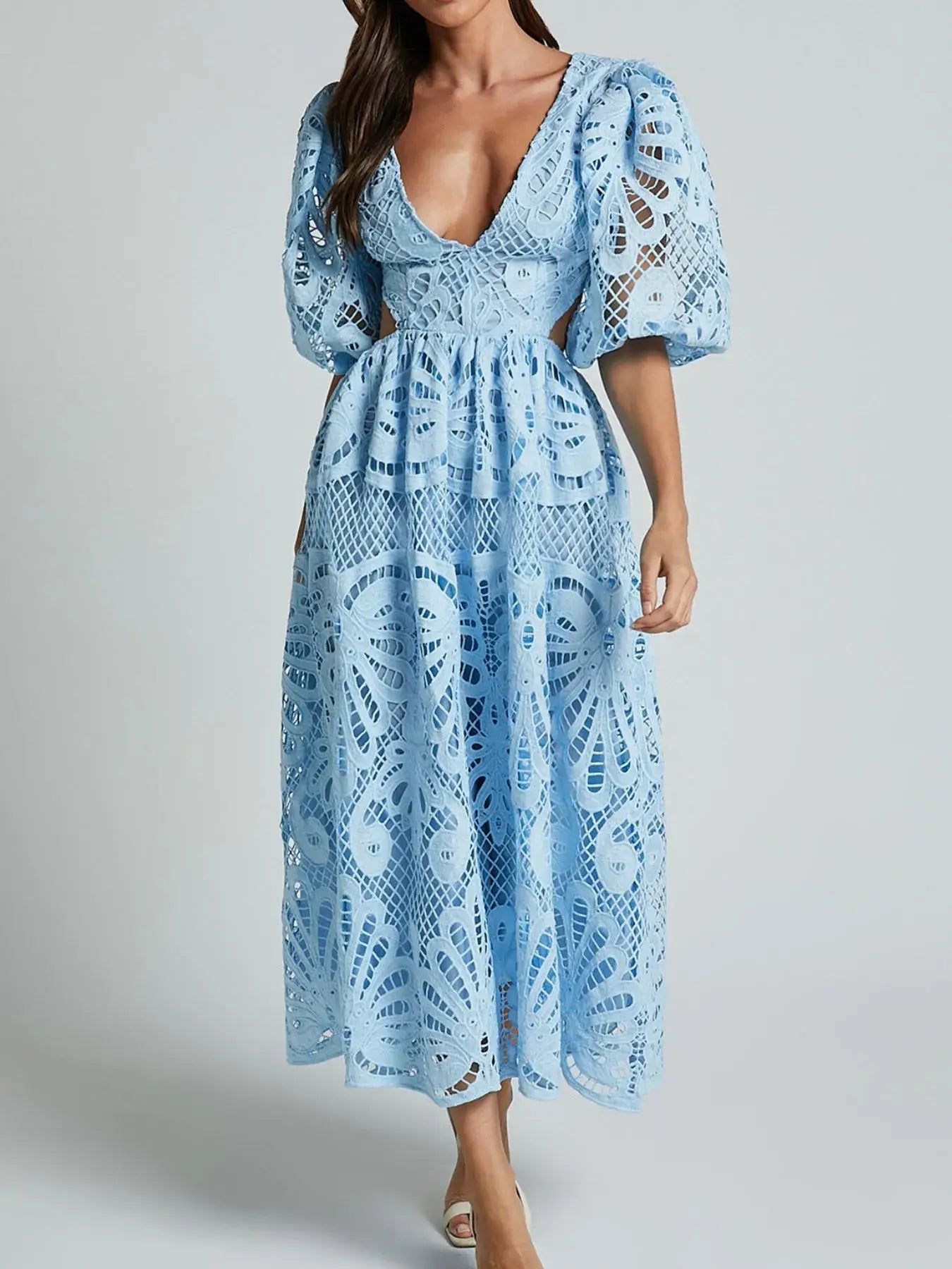 Woman wearing blue lace crochet dress with cutout back and V-neck, perfect for special occasions.