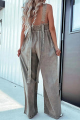 Rear view of khaki V-Neck Sleeveless Denim Jumpsuit showing smocked back and loose-fitting wide-leg design.
