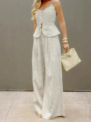 Lightweight cotton two-piece set featuring a V-neck cami and wide-leg pants, styled with button and tie details.