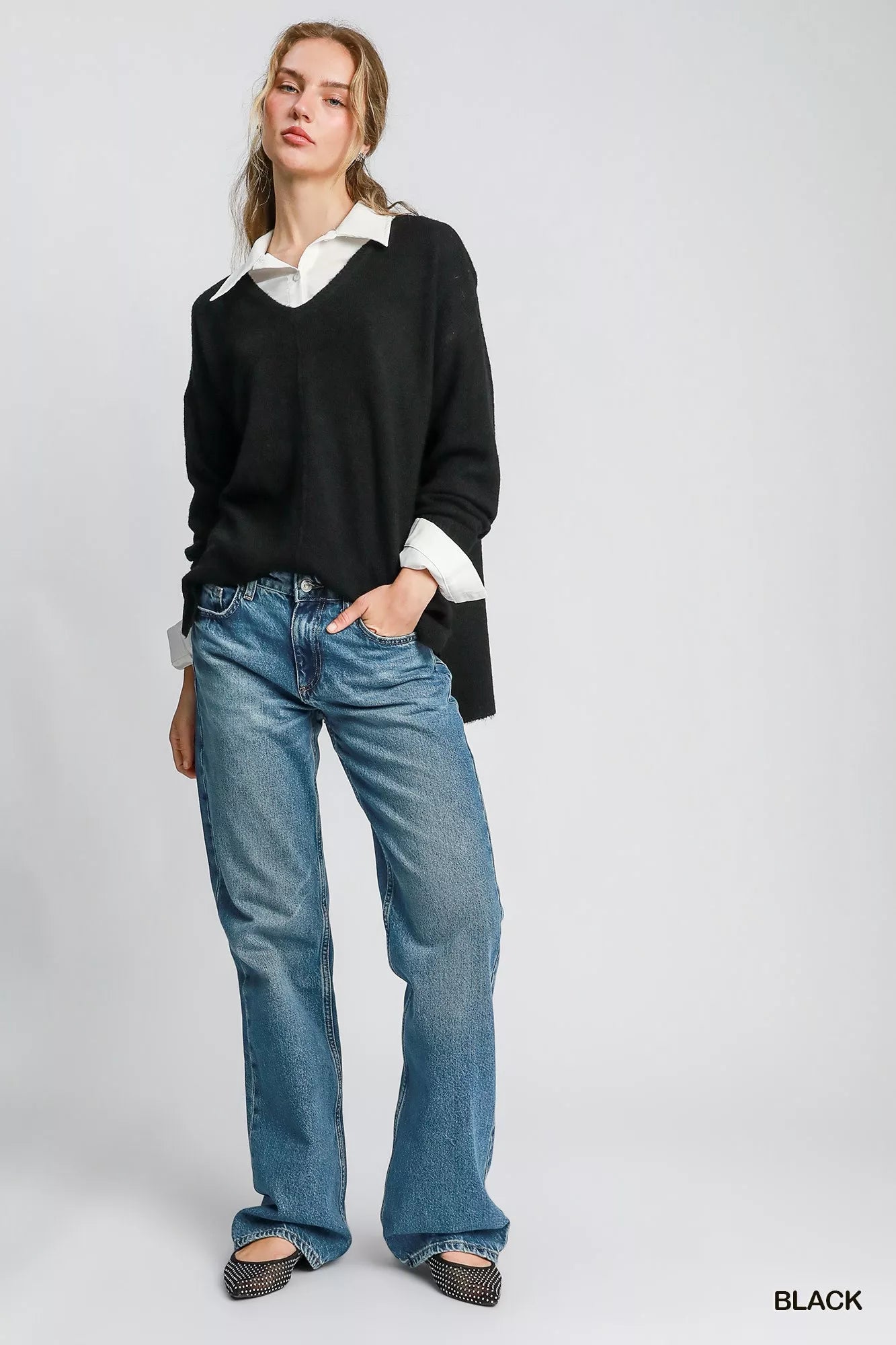 Model wearing black Umgee Wool Blended Pullover Sweater with jeans and a white shirt underneath.