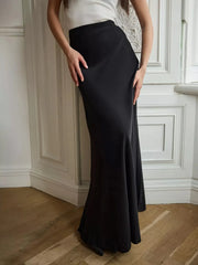 Female model wearing a High-Waisted Maxi Skirt in black, showcasing basic style. Made from polyester and spandex. Ideal for fashion enthusiasts.