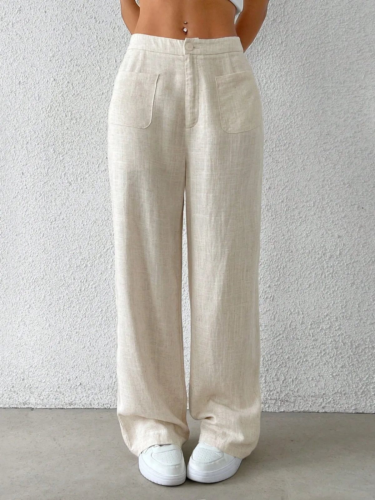 Fashionable Chic Wide-Leg Pants by GirlSavvi in light beige with pockets, styled with casual white sneakers.