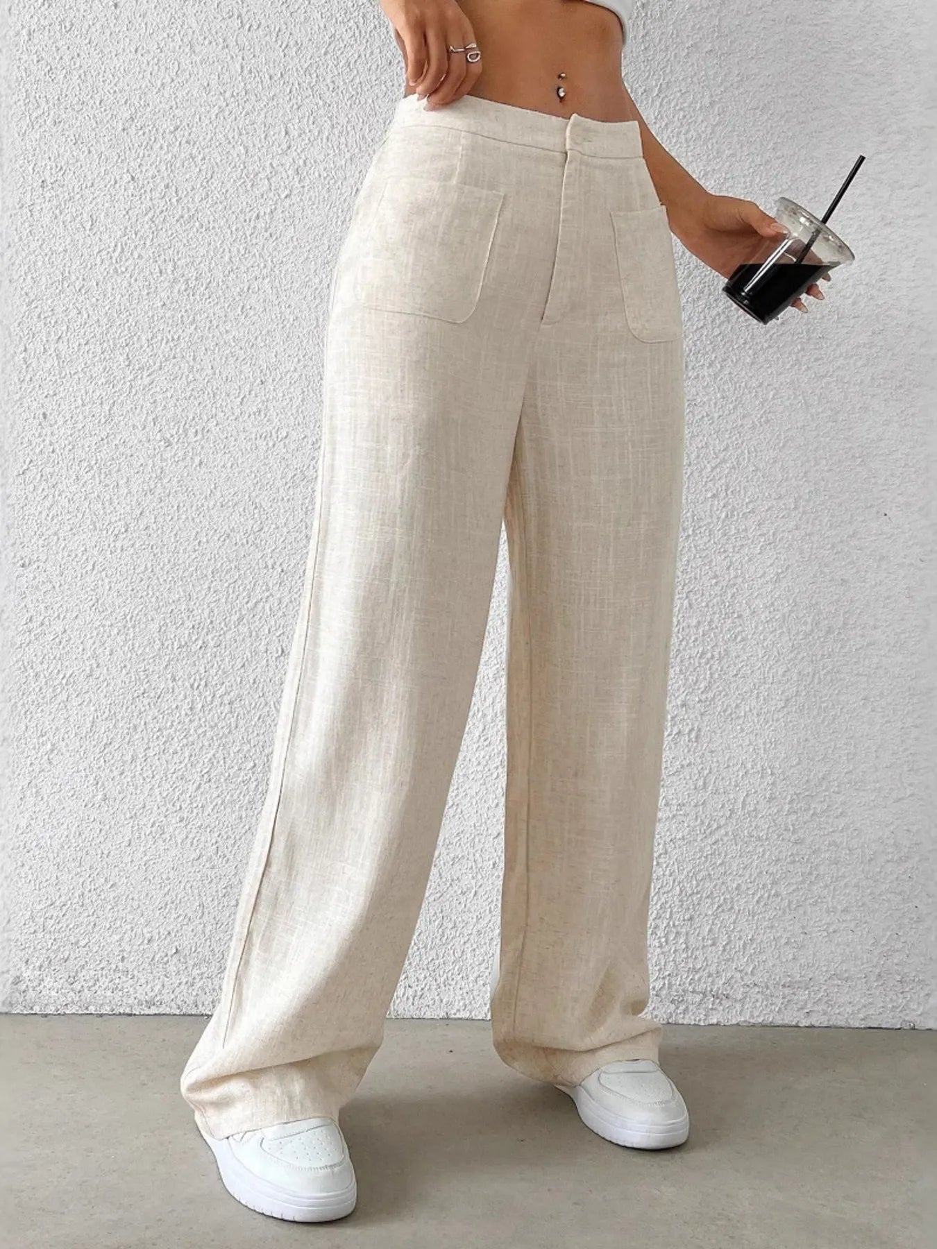 Fashionable Chic Wide-Leg Pants by GirlSavvi, cream pants with pockets, styled with white sneakers and a drink.