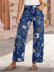 Floral Print Wide Leg Jeans worn by a model in a sunny outdoor setting, showcasing a vibrant floral design and pocketed style.