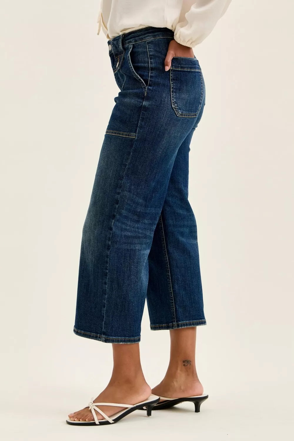 Side view of Judy Blue High Waist Wide Crop Utility Jeans worn by a model in white sandals