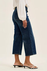 Side view of woman wearing Judy Blue High Waist Wide Crop Utility Jeans with a white blouse and sandals, showcasing modern style.