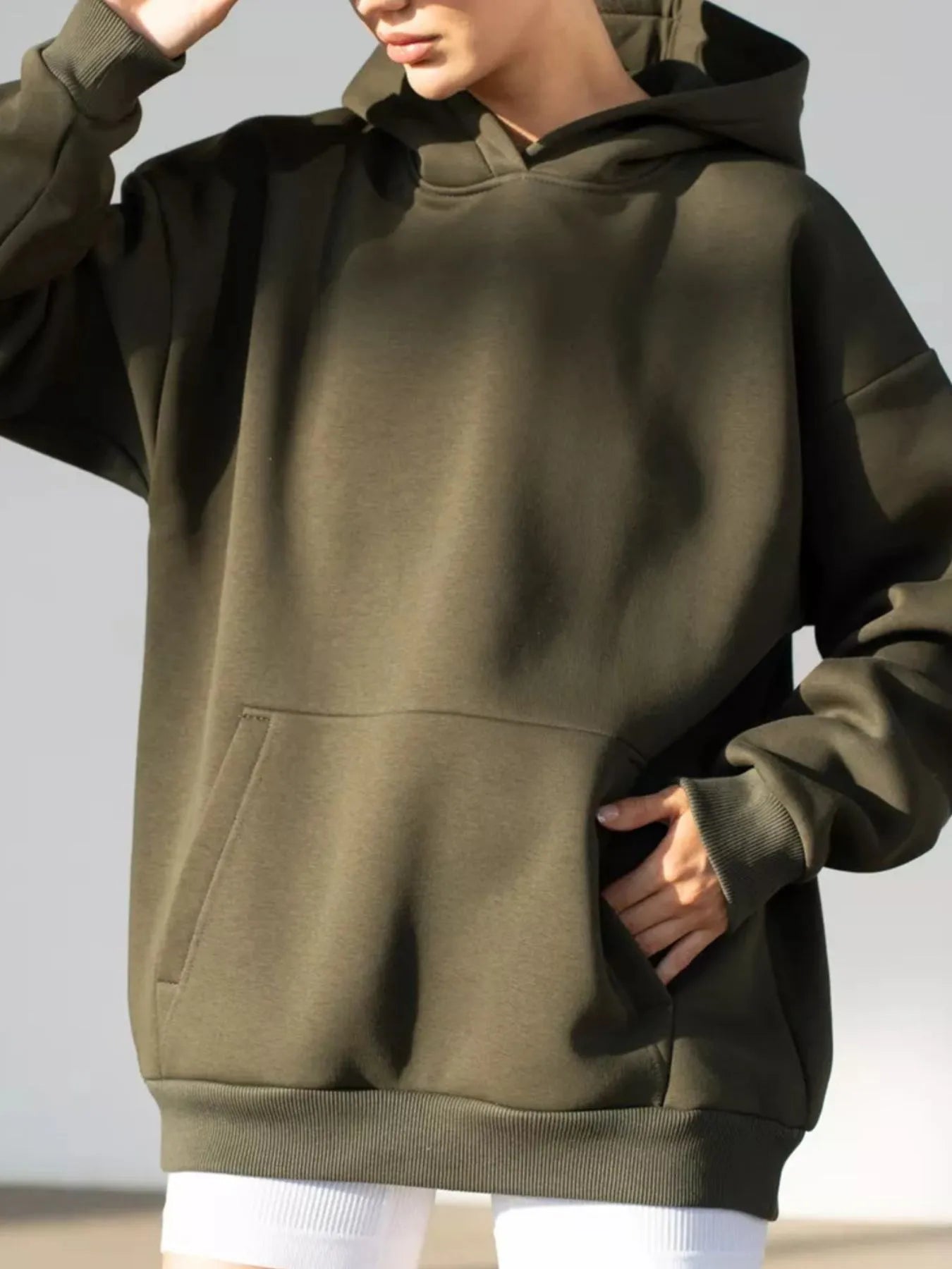 Kangaroo pocket long sleeve hoodie in olive green with comfortable fit and slight stretch for ease of movement.