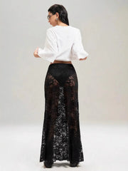 Model wearing stylish sheer black lace maxi skirt with elegant design, perfect for layering over bodysuits or swimwear.