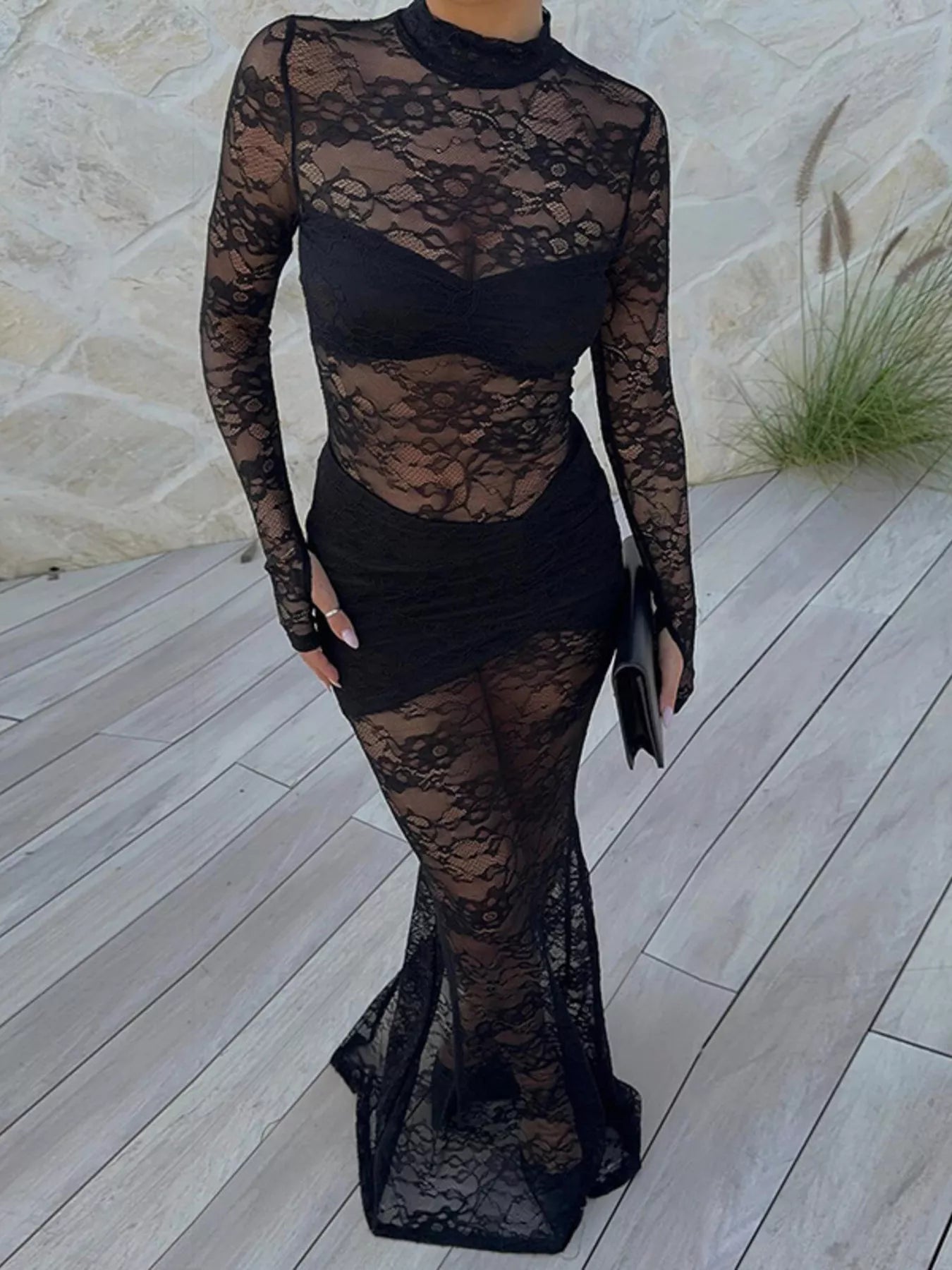 Woman wearing Lace Sheer Mock Neck Long Sleeve Maxi Dress on a patio, showcasing the elegant sheer floral design with high neckline.