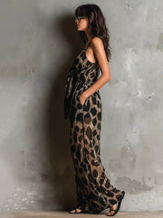 Leopard Front Tie Detail Wide-Leg Jumpsuit modeled by a woman, featuring a tied design and pockets against a textured background.
