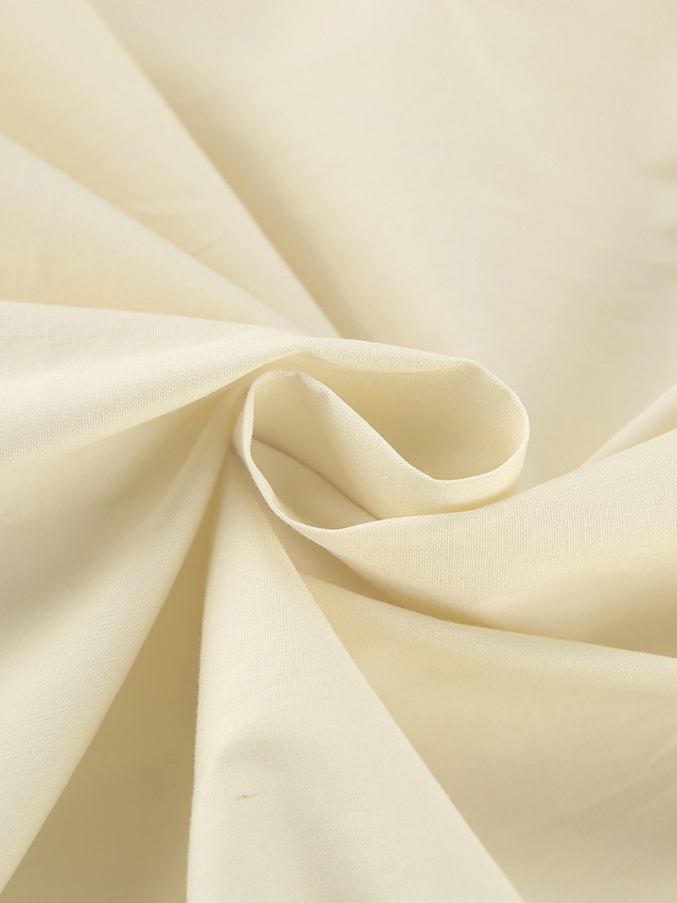 Close-up of lightweight fabric used in the Button Front Bubble Hem Dress, showcasing its smooth texture and quality.