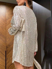 Back view of a shimmering Midnight Muse Dress with adjustable tie-waist, showcasing its elegant and sophisticated design.
