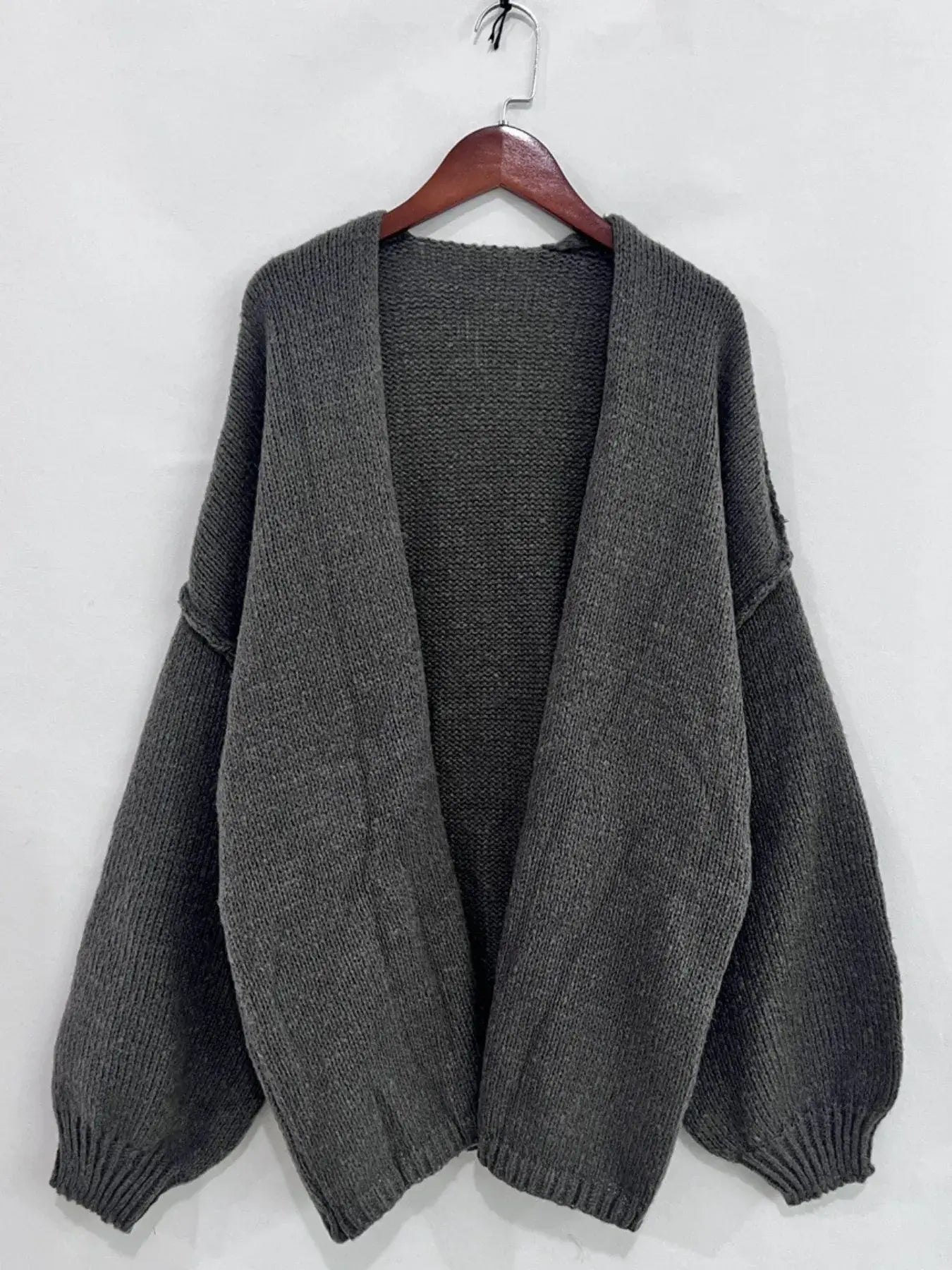 Oversized open front dropped shoulder cardigan with textured soft-touch polyester and voluminous sleeves on hanger.