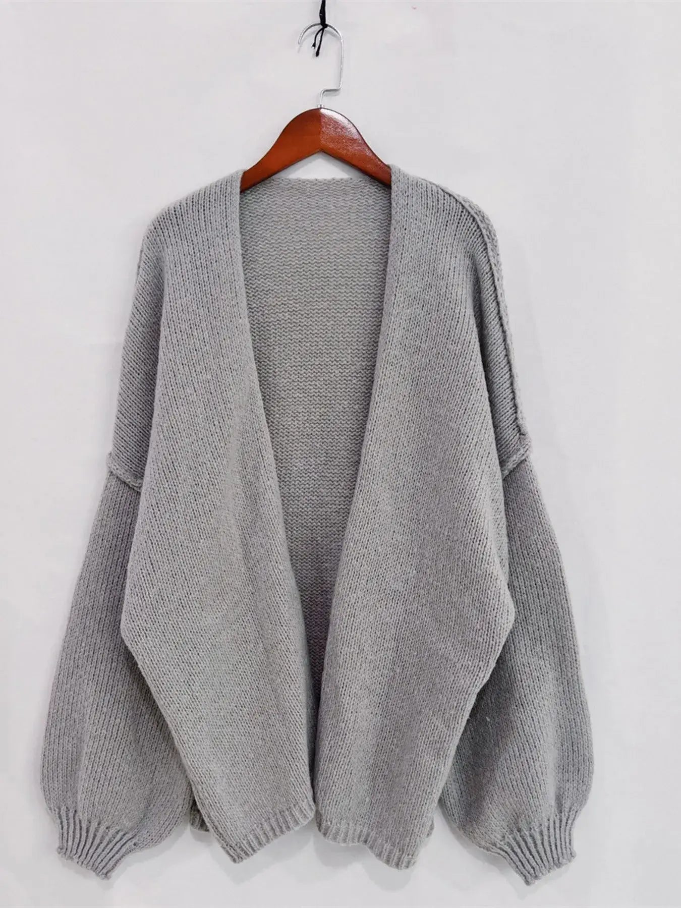Open front dropped shoulder cardigan in gray, oversized with textured knit and voluminous sleeves, perfect for chic layering.