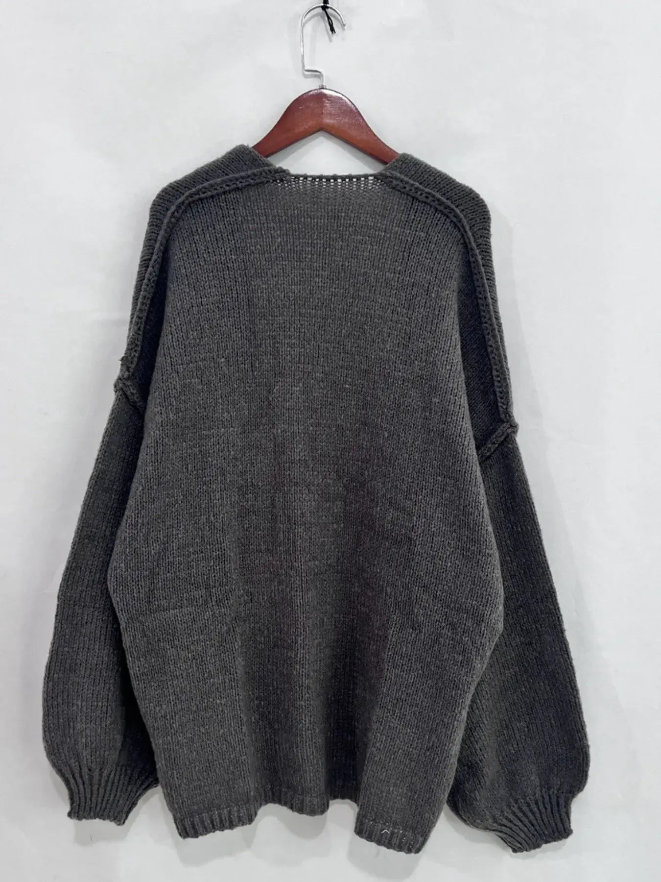 Back view of Open Front Dropped Shoulder Cardigan in gray, showcasing its oversized textured design and voluminous sleeves.