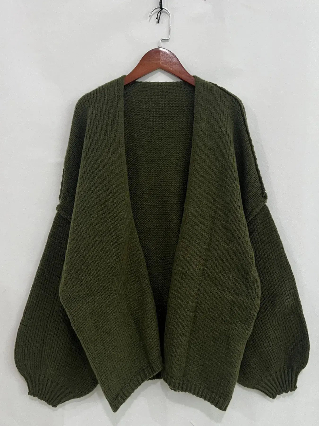 Olive oversized open front dropped shoulder cardigan with textured fabric, featuring voluminous sleeves. Perfect for layering in chic style.