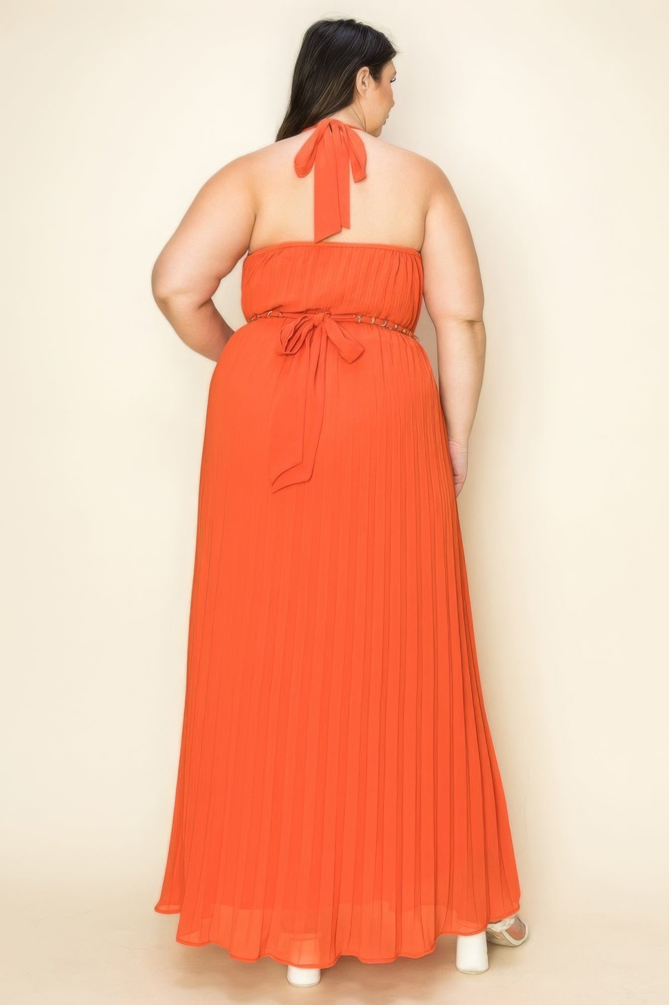 Back view of a woman wearing a Chiffon Pleated Gold Trim Maxi Dress in orange, showcasing its elegant pleated design.