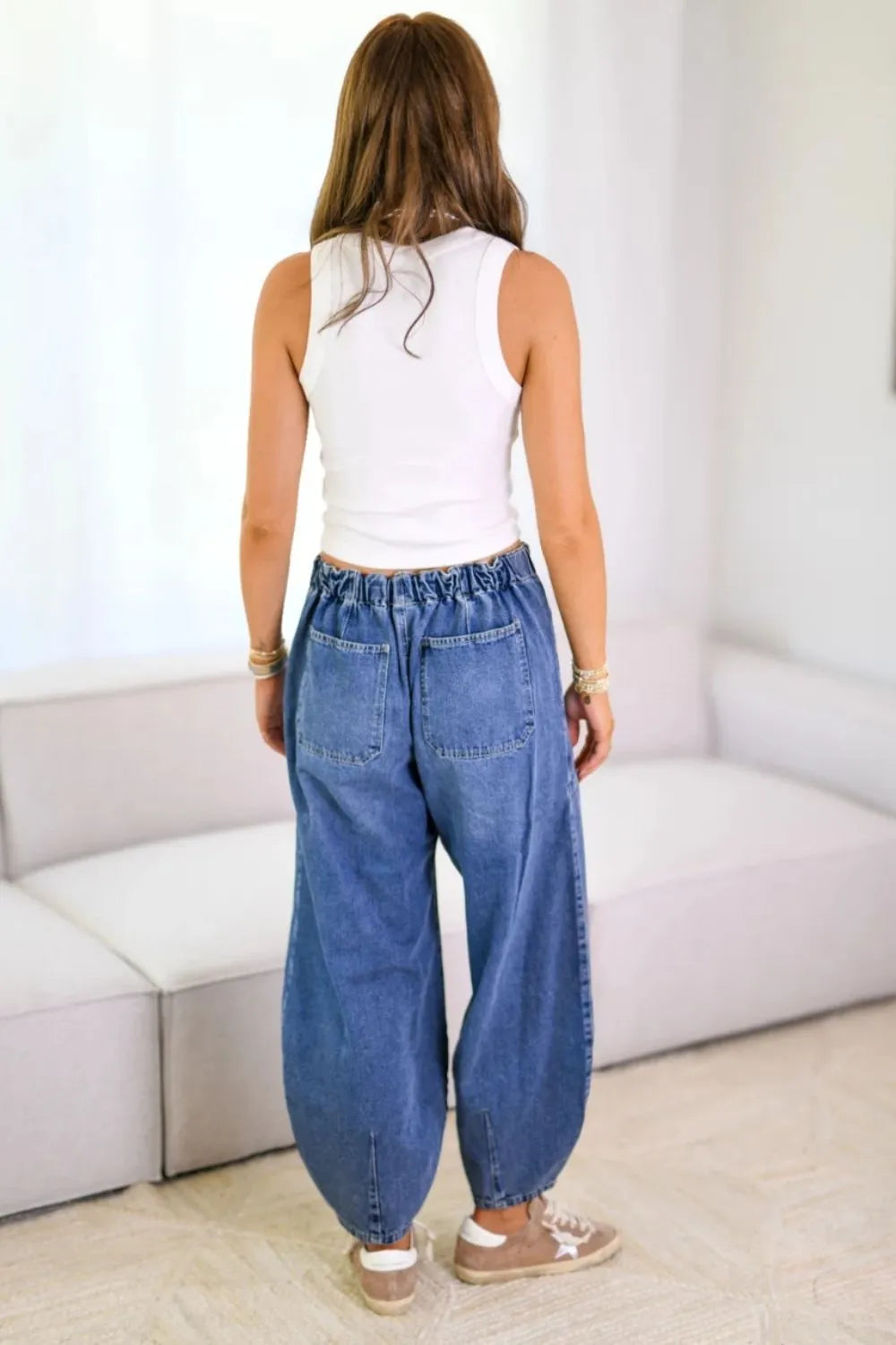 Woman wearing Relaxed Drawstring Jeans with Pockets, showcasing a relaxed fit and elastic waistband from the back.