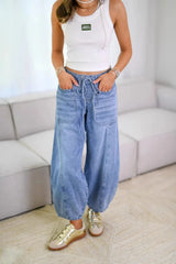 Relaxed Drawstring Jeans with Pockets worn by a model, featuring an elastic waistband and oversized front patch pockets.