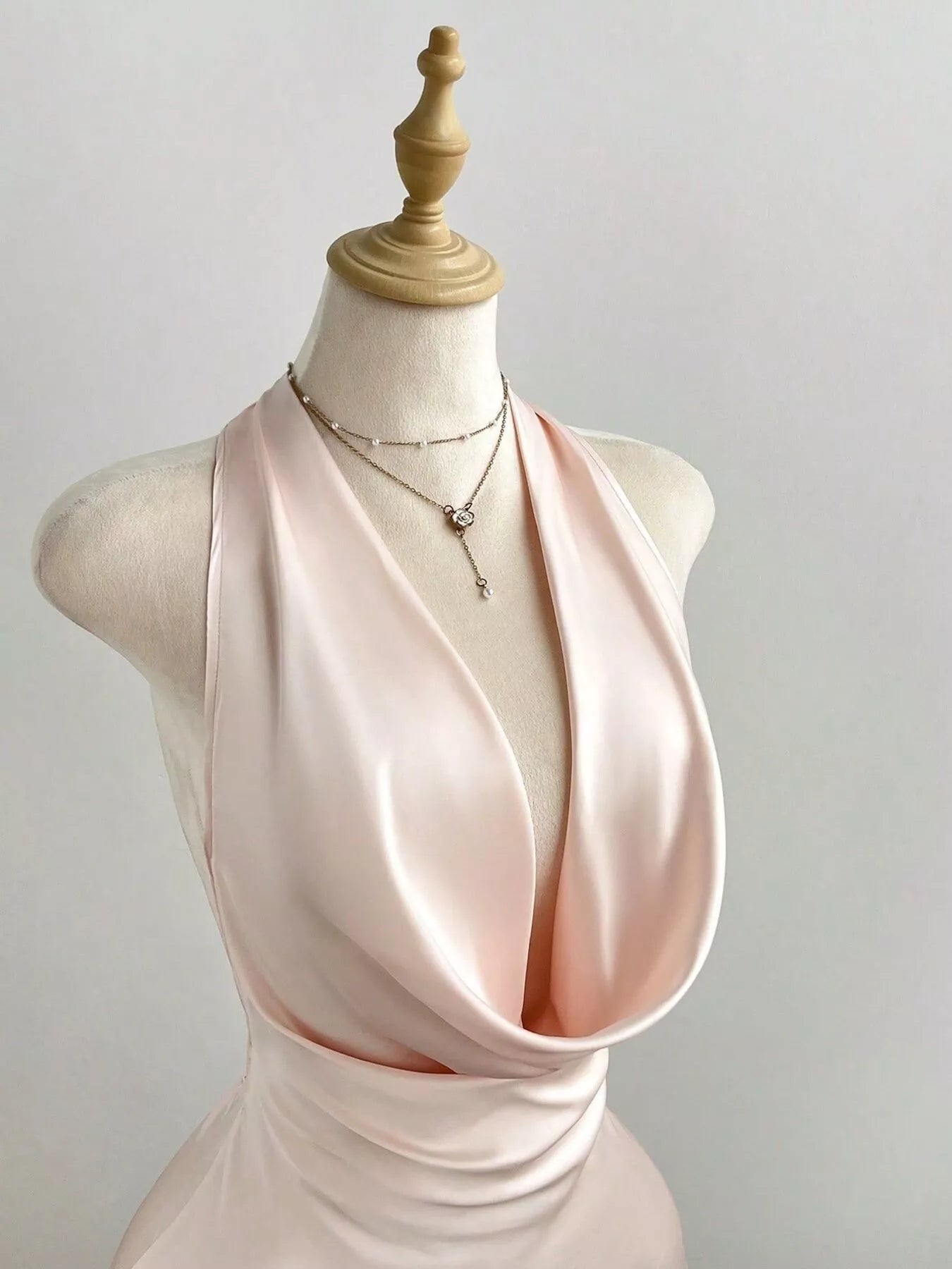 Satin Backless Halter Neck Dress featuring a deep neckline, ruched detailing, and elegant satin fabric.