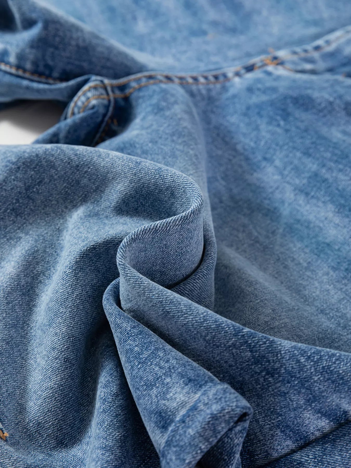Close-up of blue denim fabric from Seam Detail Loose Fit Cropped Jeans, showcasing subtle seam detailing and soft texture.