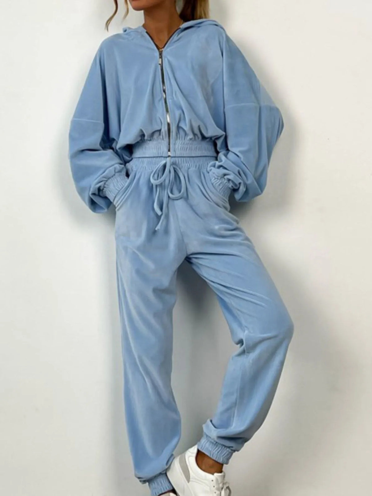 Sky blue zip-up long sleeve top and pants set with drawstring waist and white sneakers, ideal for lounging or casual outings.