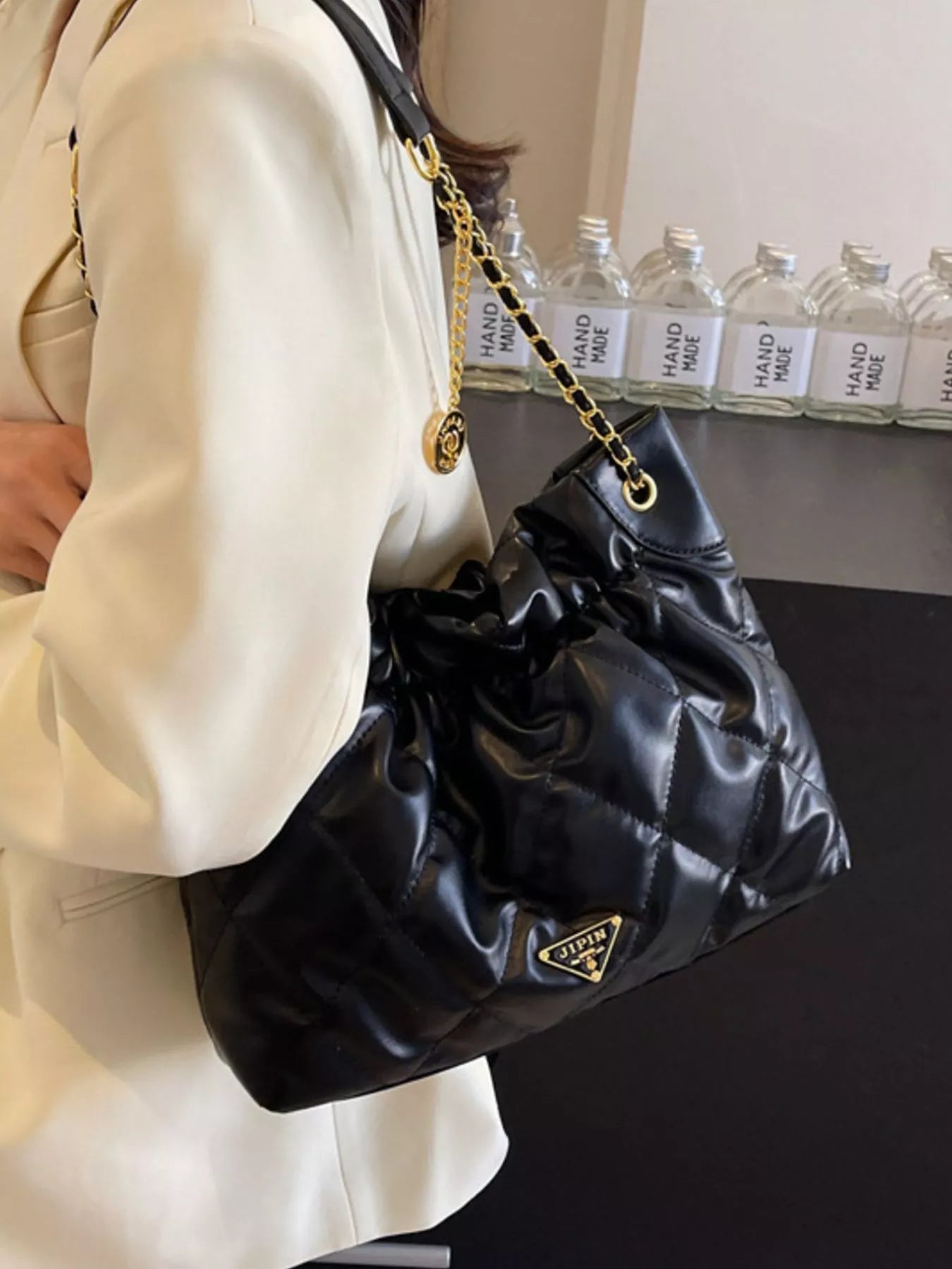 Summer Ruched Leather Shoulder Bag showcased in a stylish setting, highlighting its medium size and fashionable design.